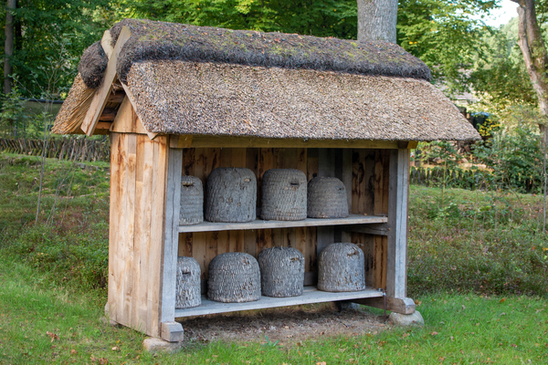 An ancient beehive made of wood and straw.  